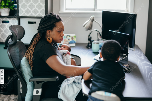 Black mother working from home with children, professional businesswoman