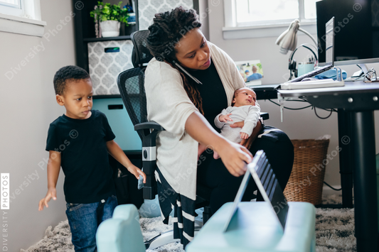 Black mother working from home with children, professional businesswoman