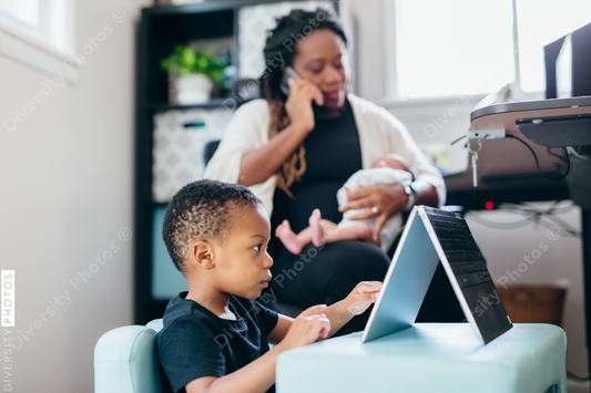 Black mother working from home with children, professional businesswoman