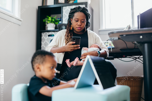 Black mother working from home with children, professional businesswoman