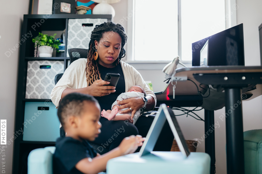 Black mother working from home with children, professional businesswoman