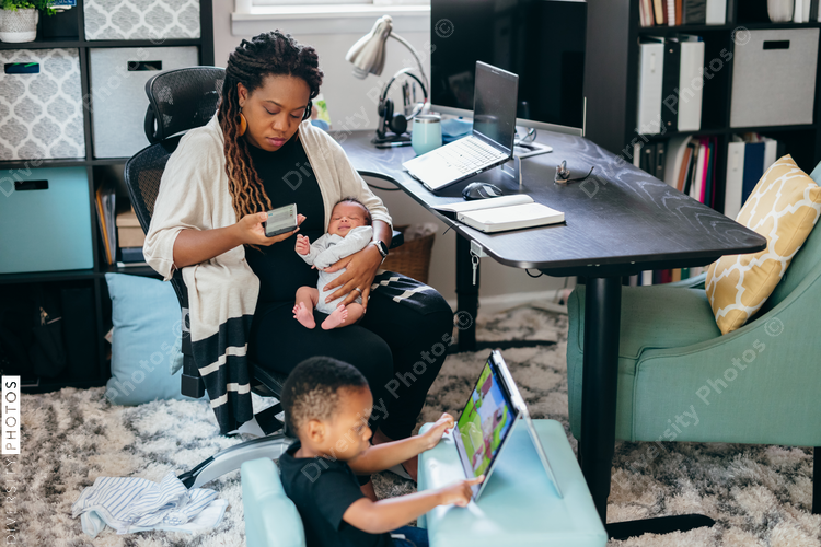 Black mother working from home with children, professional businesswoman