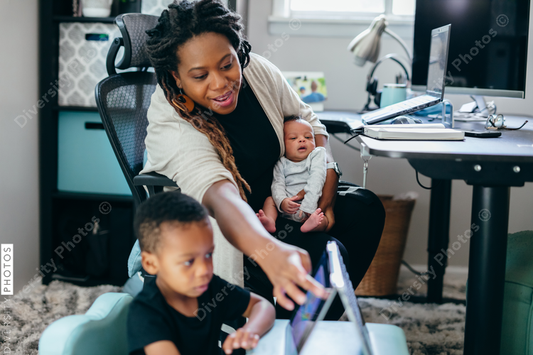 Black mother working from home with children, professional businesswoman