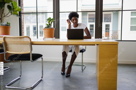 Black Business woman using laptop in office