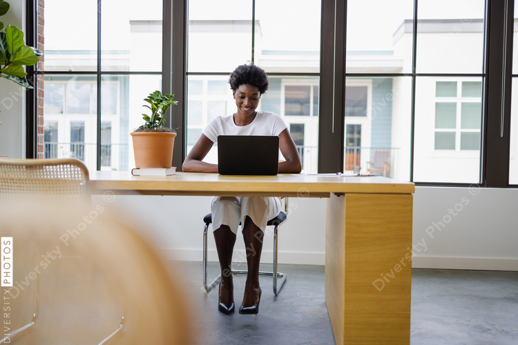 Black Business woman using laptop in office