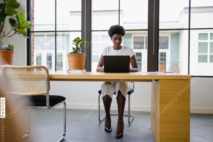 Black Business woman using laptop in office