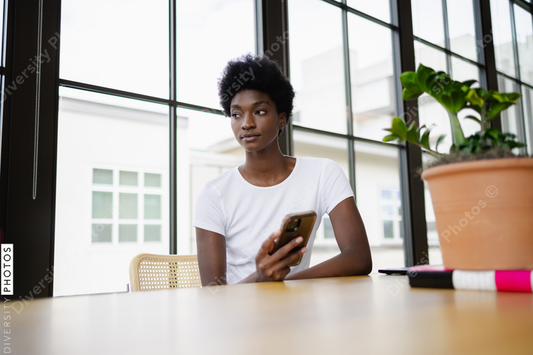 Black Business woman using smart phone in office