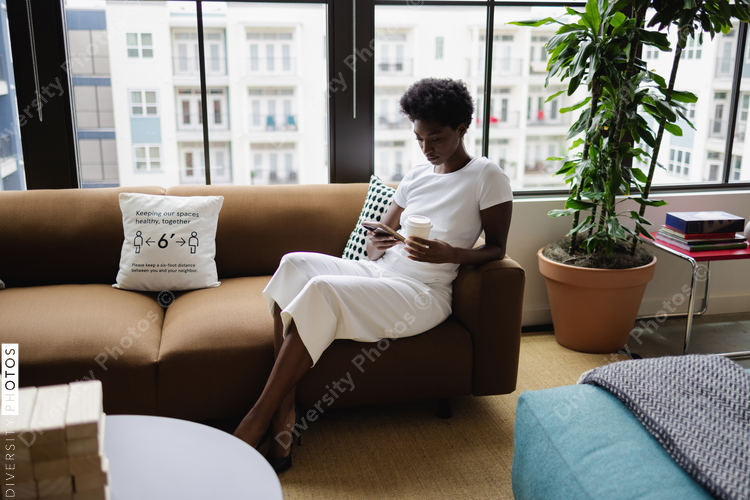 Business woman sitting on sofa in office
