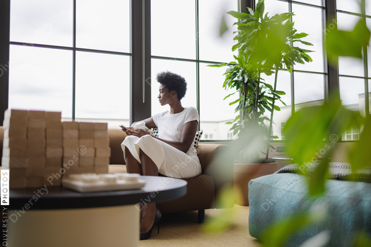Black Businesswoman sitting on sofa in office