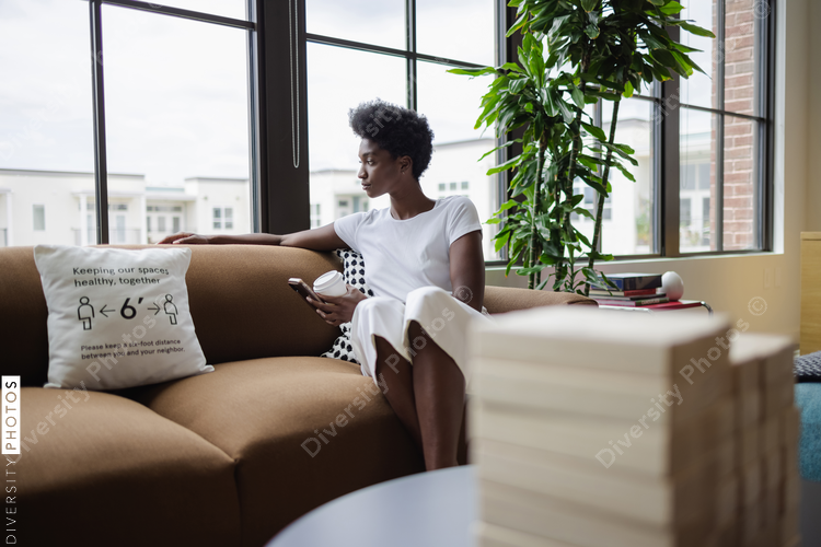 Business woman sitting on sofa in office
