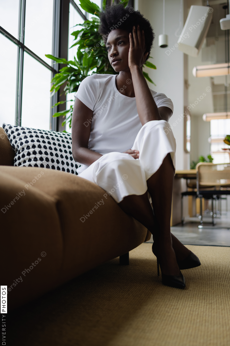 Business woman sitting on sofa in office