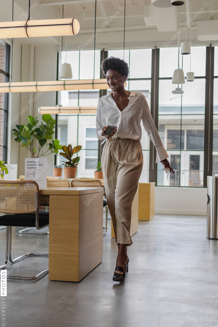Black Business woman walking in office space