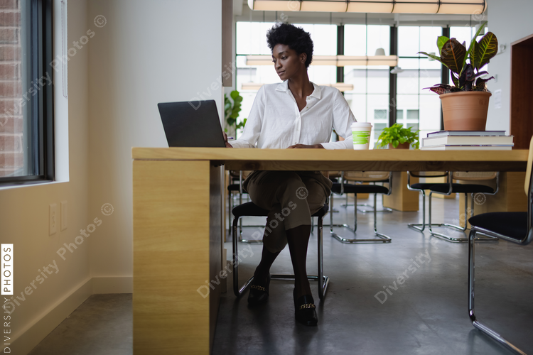 Black Business woman with laptop in office