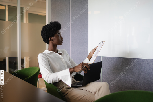 African American Business woman with laptop in front of whiteboard