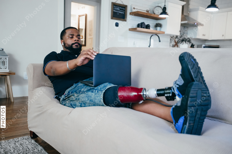 Man with disability working from home on laptop