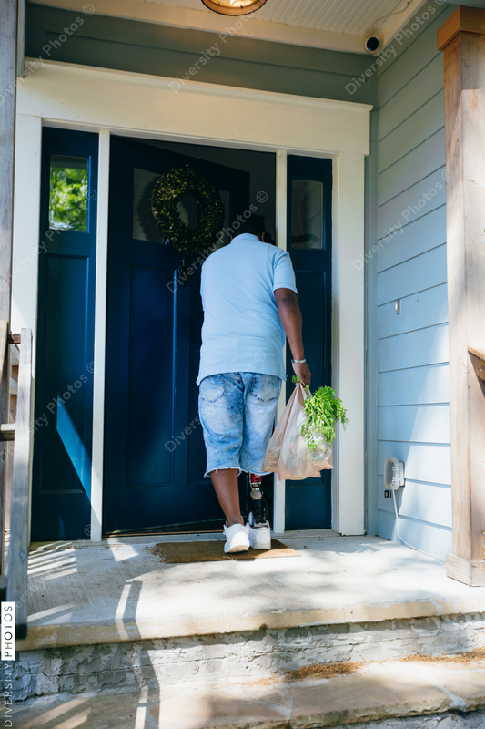 African American man brings home groceries
