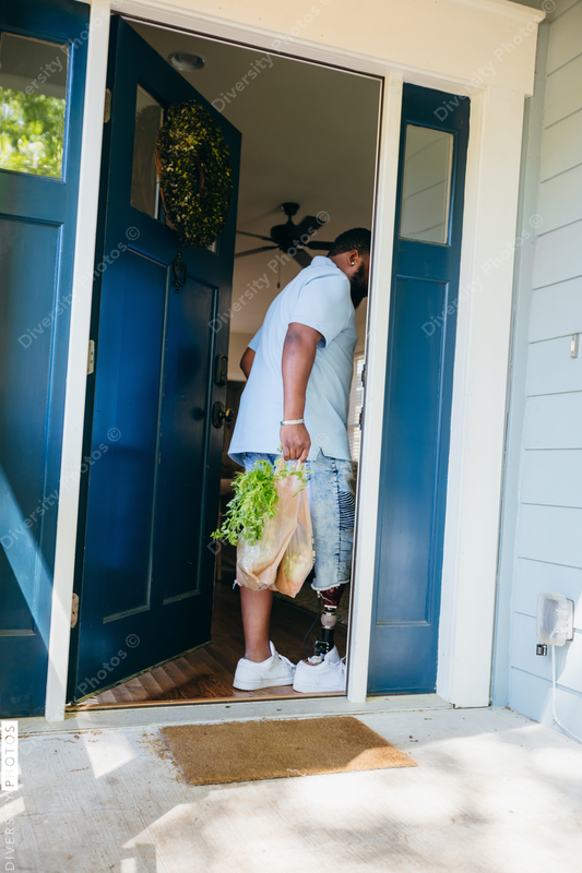African American man brings home groceries