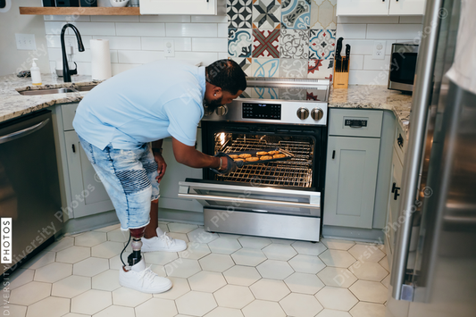 Black man bakes cookies in kitchen, disabled