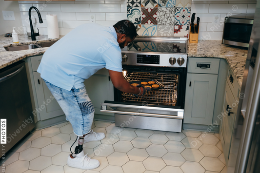 Black man bakes cookies in kitchen, disabled