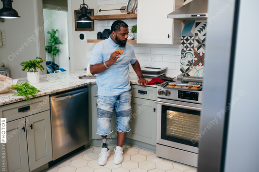 Black man bakes cookies in kitchen, disabled