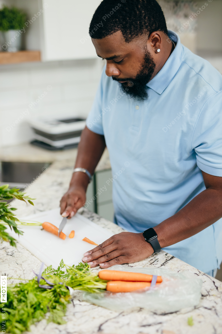 Black man in kitchen preparing healthy meal