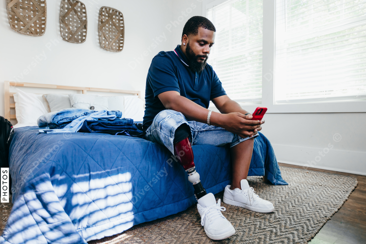 Young Black man takes selfie with phone
