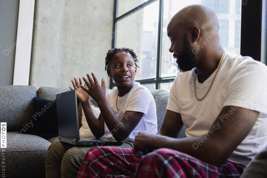 Black son explains schoolwork to dad