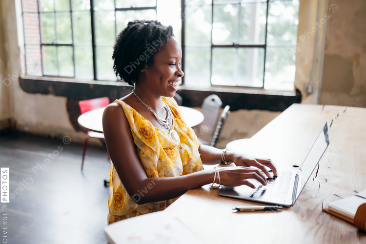 Thoughtful businesswoman using laptop, African American