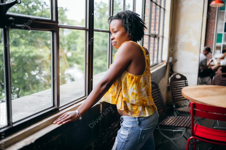 Portrait beautiful thoughtful young businesswoman in coworking space, African American woman