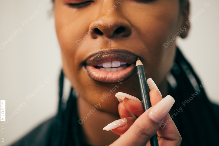 Black woman getting makeup on face