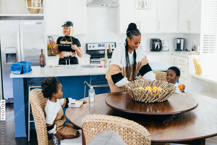Black stay at home mother eats lunch with son and daughter