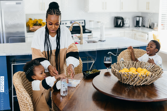 Black stay at home mother eats lunch with son and daughter