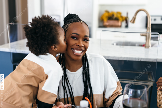 black girl kisses mother on cheek