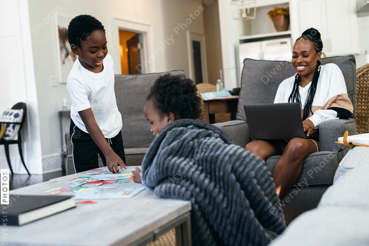 Black kids playing board games, puzzle, at home, while mom is working
