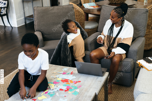 Black kids playing board games, puzzle, at home, while mom is working