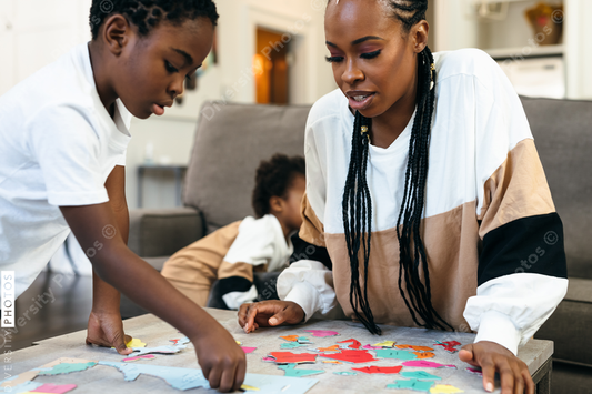 Black mother and kids put together africa puzzle 