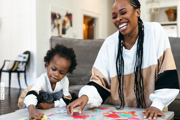 Black mother and kids put together africa puzzle 