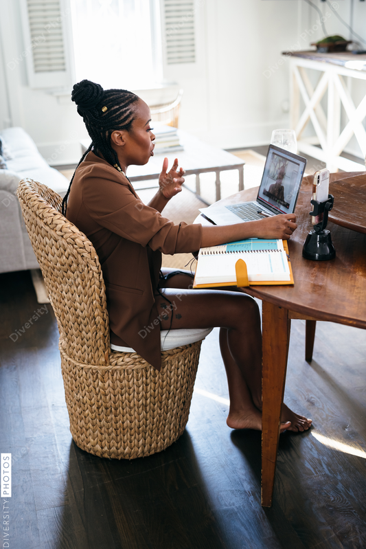 African American woman works from home on video chat meeting