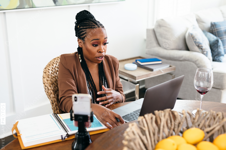 African American woman works from home on video chat meeting