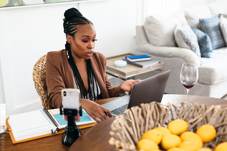 African American woman works from home on video chat meeting