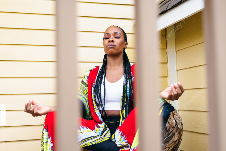 African american woman meditates at home outdoors