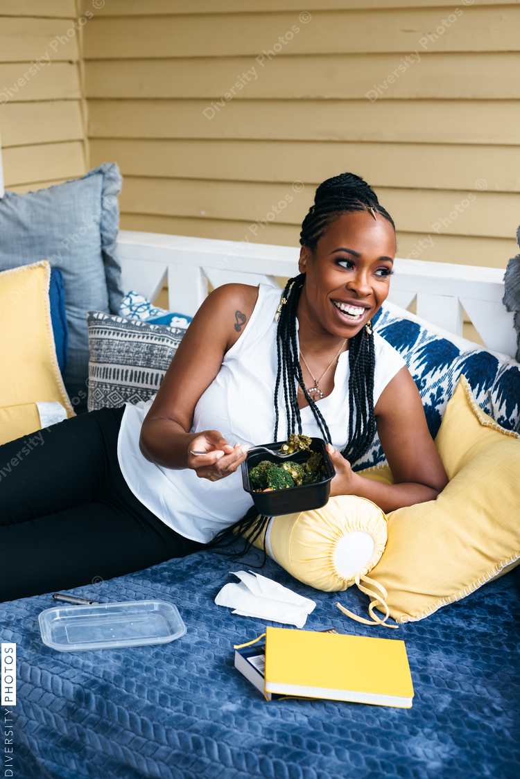 Black woman eating healthy vegetables - vegetarian 