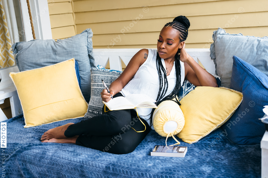 African American woman writing in journal - mindfulness 