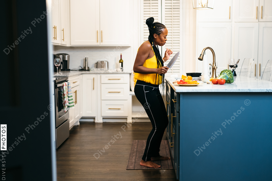Black woman cooking and dancing in kitchen