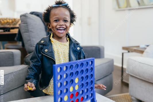 Young black girl plays games at home