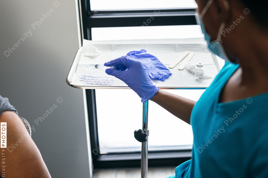 Black senior man gets vaccine, from nurse at doctors office