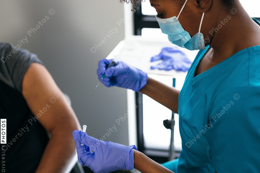 Black senior man gets vaccine, from nurse at doctors office