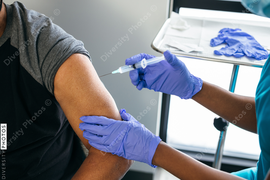 Black senior man gets vaccine, from nurse at doctors office