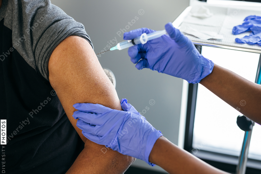Black senior man gets vaccine, from nurse at doctors office