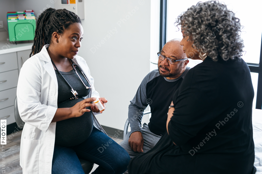 African American female doctor consults with senior medical patients about prescription drugs